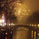 Fireworks smoke over an Amsterdam canal on New Year Eve
