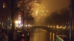 Fireworks smoke over an Amsterdam canal on New Year Eve