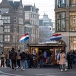 Herring stall on an Amsterdam street, with customers queueing