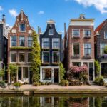Five charming short stay rental apartments along a calm canal in Amsterdam with bicycles and outdoor seating.