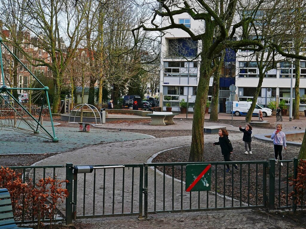 Dutch children playing at a playground on Frederiksplein in Amsterdam