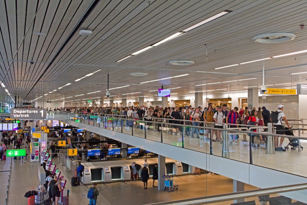 Passengers queuing at security control at Schiphol Airport