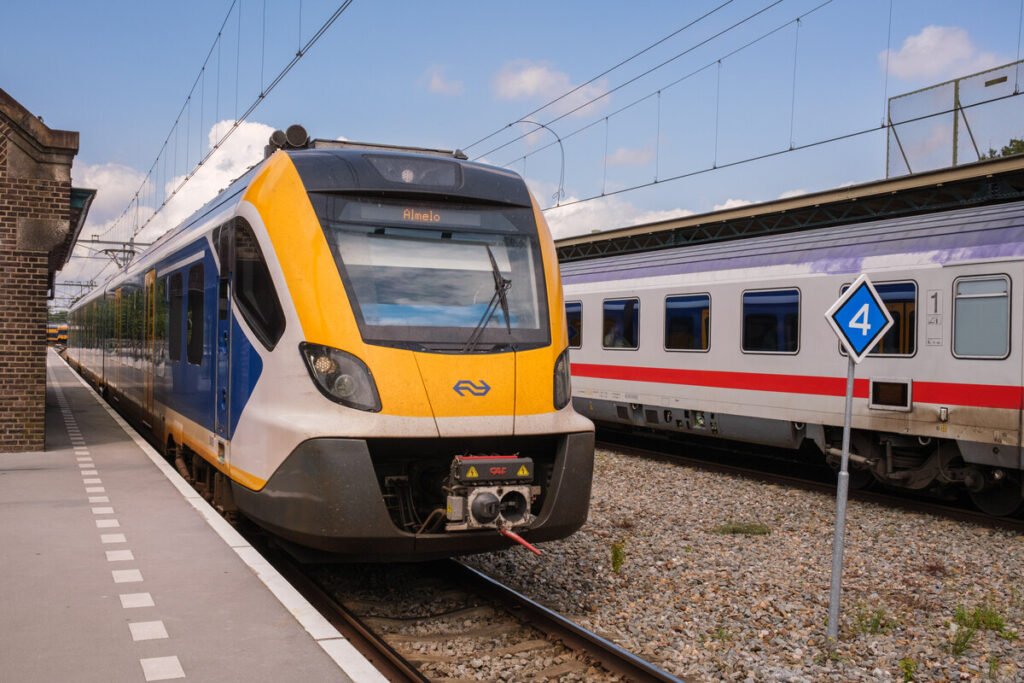 A yellow and blue NS Sprinter train standing at a platform in the Netherlands