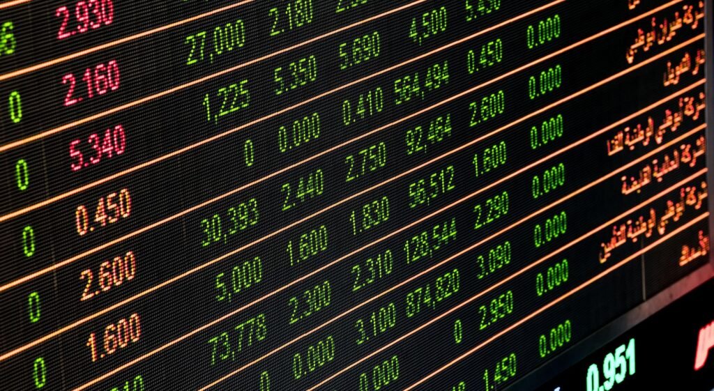 Stock market price board showing share prices in red and green