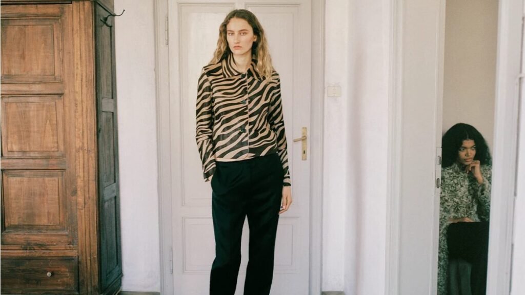 A model in a zebra-print leather jacket in a hallway