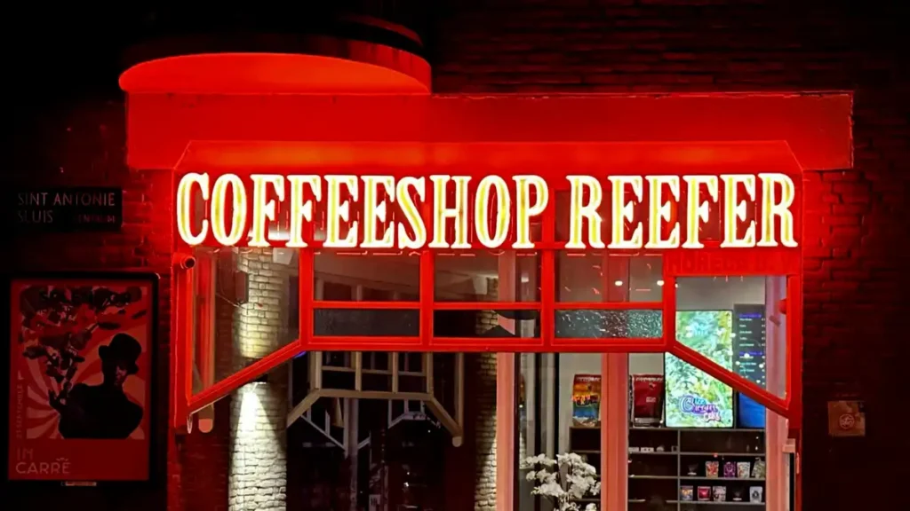 Coffeeshop Reefer in Amsterdam at night, its red neon sign lit