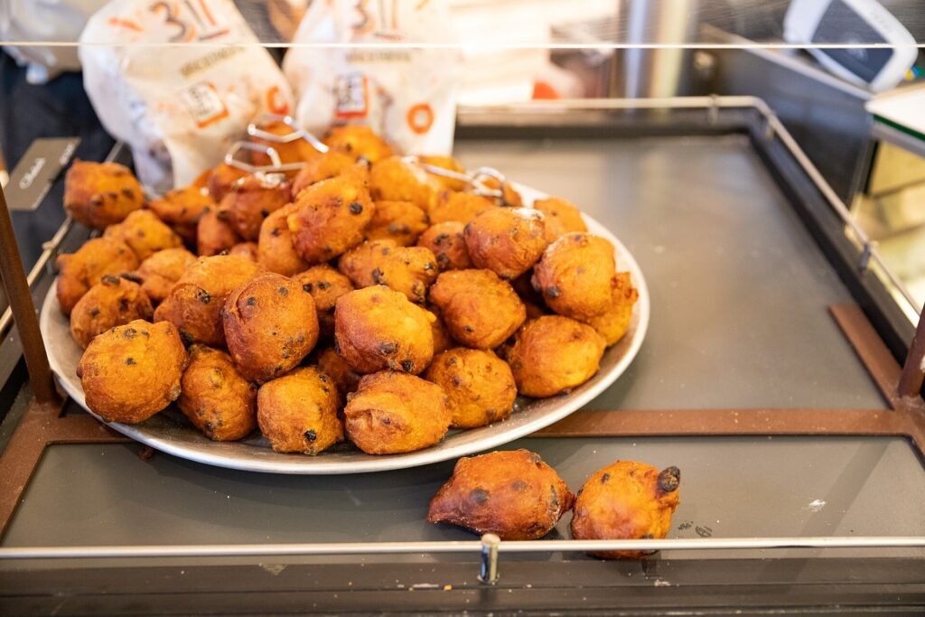 A plate of fresh oliebollen at an oliebollen stall