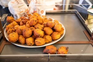 A plate of fresh oliebollen at an oliebollen stall