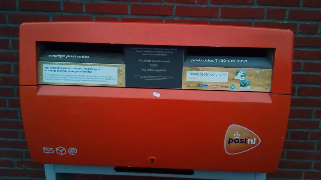 An orange PostNL post box